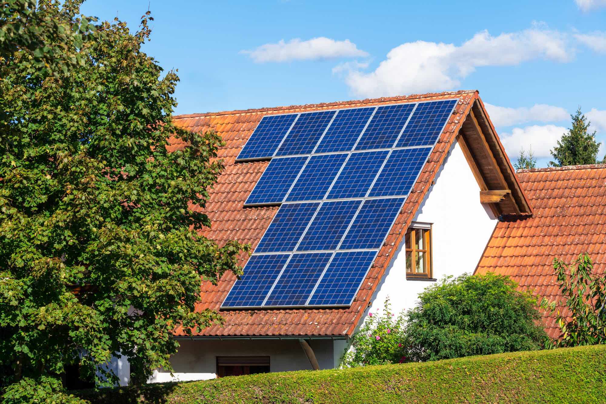 Haus mit Photovoltaikanlagen in Vorarlberg auf dem Ziegeldach zur nachhaltigen Stromerzeugung.